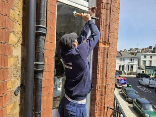 man installing window