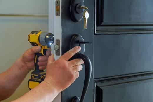 man installing door